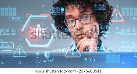 Portrait of thoughtful young businessman using laptop in blurry office with double exposure of immersive cybersecuity bug interface. Concept of data protection and online privacy