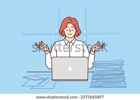 Business woman meditates sitting at office desk with papers and laptop and taking short break. Businesswoman meditates in lotus position and uses yoga practices to be more productive Royalty-Free Stock Photo #2375685897