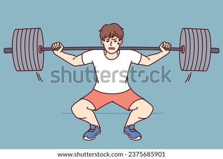 Man squats with barbell on shoulders, doing weightlifting in gym and trying to set new sports record. Guy wants to become professional bodybuilder lifts barbell to build muscle and succeed in fitness Royalty-Free Stock Photo #2375685901