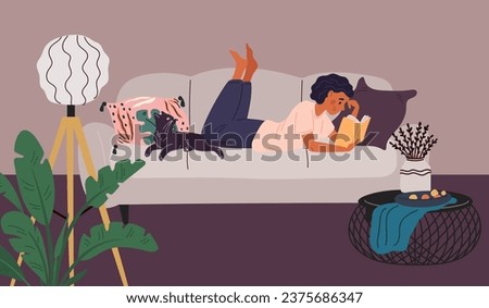 Woman reading book in living room. Reader in cozy home interior. Girl lying on sofa with literature volume. Recreation or education. Female enjoying of novel. Garish Royalty-Free Stock Photo #2375686347