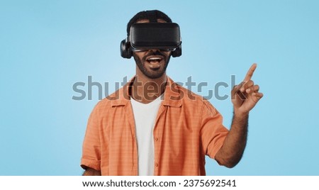 Man, virtual reality and glasses in studio with hand, click and swipe with smile for metaverse by blue background. Person, AR vision and futuristic game with 3D user experience, cyber ui and esports