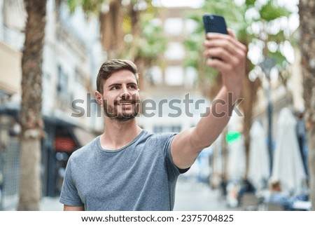 Young caucasian man smiling confident making selfie by the smartphone at street