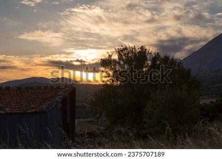 sunset on the Abruzzo hills in Italy with old tool shed. High quality photo