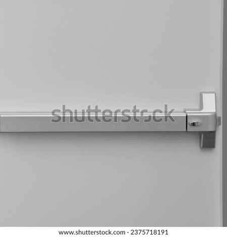 Emergency exit door. Closed up latch door handle of emergency exit. Push bar and rail for panic exit