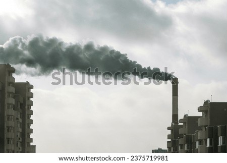 Environmental problem of city air pollution - Industrial pipe factory construction and residential building area over Steam and smoke emissions. grunge filter photo