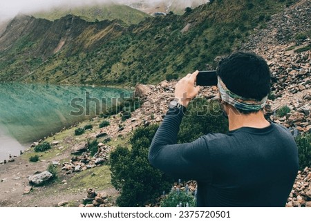 man clicking pictures during trekking adventure