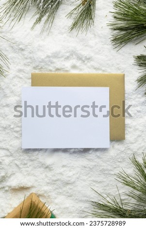 Christmas decorations and white card with copy space on snow background. Christmas, decorations, tradition and celebration concept.