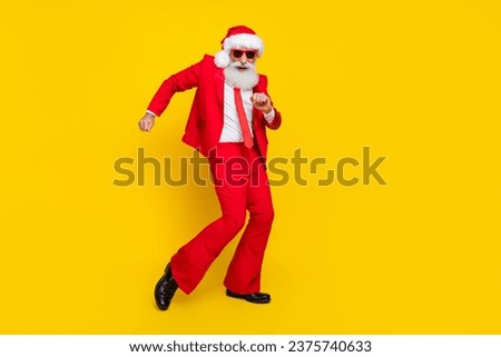 Full length photo of sweet cheerful santa dressed red suit tie having fun discotheque dancing empty space isolated yellow color background