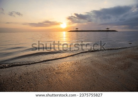 Landscape shot in Bali. Sunrise or sunset at Sanur beach. Beautiful sandy beach in the morning, with fine sand and a view of the calm sea. Temples are in the water. A dream in Indonesia Royalty-Free Stock Photo #2375755827