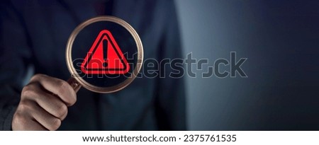 Red triangle caution in magnifier magnifying. Businessman hold Magnifier magnifying focus alert danger warning icon sign for notification error and maintenance. Royalty-Free Stock Photo #2375761535