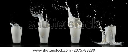 Glass of Milk Exploding against White Background