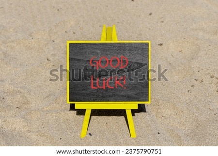 Good luck symbol. Concept words Good luck on beautiful black chalk blackboard. Beautiful sea sand beach background. Business, motivational good luck concept. Copy space.