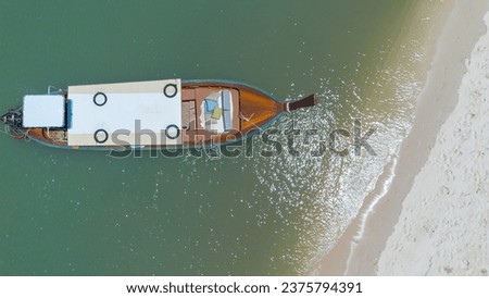 Beautiful sea wave with local long-tail boat looking from top. Summer in Krabi, Thailand. 