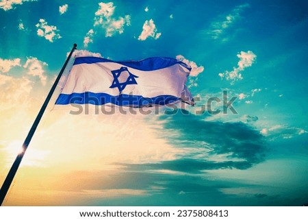 Flag of Israel fluttering against sunset sky Royalty-Free Stock Photo #2375808413