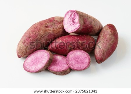 Fresh purple sweet potato on white background