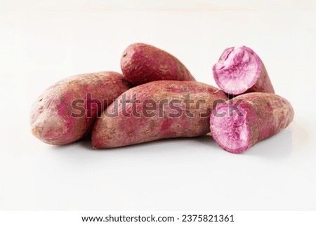 Fresh purple sweet potato on white background