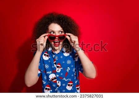 Photo portrait of lovely young lady look interested empty space wear trendy blue print x-mas garment isolated on red color background