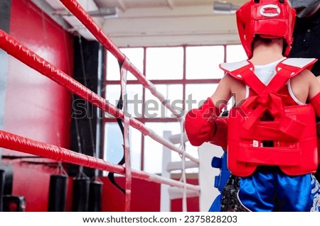 boxer in the ring. Boxer in full gear. Children's sports. Thai boxing. Boxing competition. Hand protection. Royalty-Free Stock Photo #2375828203