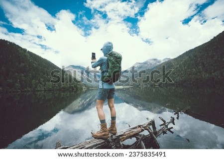 Woman walking on a one plank bridge in high altitude mountains