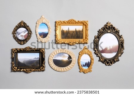 Vintage frames with beautiful photos of landscapes hanging on light gray wall