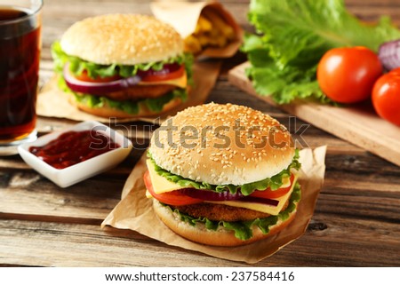 Fresh burgers on brown wooden background