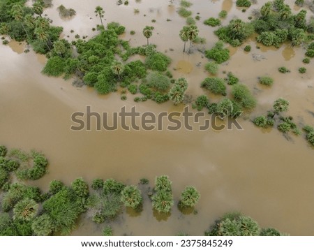 drone shot aerial view top angle panoramic photograph of dam lake reservoir river flooding overflowing erosion alluvial soil marshlands india tamilnadu swamp natural disaster monsoon mangroves 