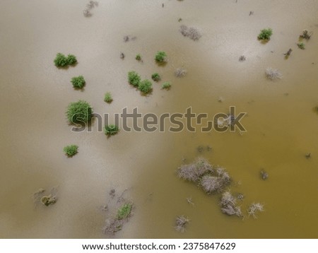 drone shot aerial view top angle panoramic photograph of dam lake reservoir river flooding overflowing erosion alluvial soil marshlands india tamilnadu swamp natural disaster monsoon mangroves  Royalty-Free Stock Photo #2375847629