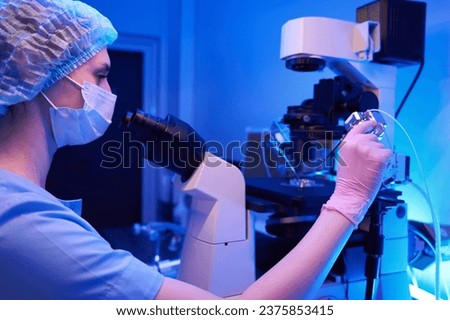Scientist doing intracytoplasmic sperm injection, micromanipulation equipment Royalty-Free Stock Photo #2375853415