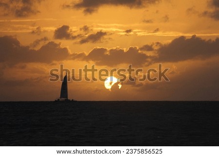 the picture perfect of a catamaran and the sunset in the carabina sea 