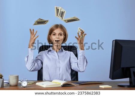 businesswoman throwing money while sitting on chair at desk.