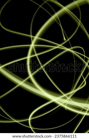 Abstract yellow light in the dark, abstract long exposure photography technique, fine lines of light, messy yellow lines against dark background, no people