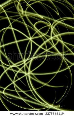 Abstract yellow light in the dark, abstract long exposure photography technique, fine lines of light, messy yellow lines against dark background, no people
