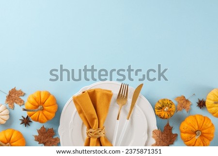 Form a Thanksgiving table that makes an impression. Top view photo of plates, cutlery, pumpkins, anise, napkin, fallen leaves on light blue background with promo space