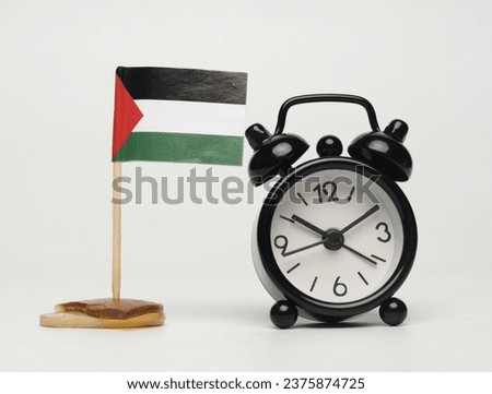 A picture of Palestinian flag with alarm clock. Palestinian will be free.