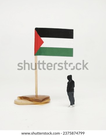 Selective focus picture of miniature watching Palestinian flag insight. Free Palestine.