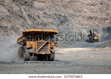 Regular maintenance and inspection are critical for mining trucks due to the harsh operating conditions they face.  Royalty-Free Stock Photo #2375876863