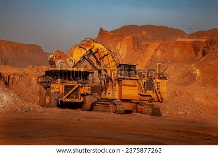 Mining trucks are crucial in the mining industry as they help move large amounts of overburden, ore, or waste material from one location to another within a mining site Royalty-Free Stock Photo #2375877263