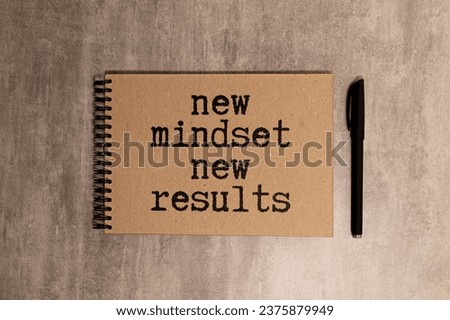 top view image of table with open notebook and the text new mindset new results. success and personal development concept. Royalty-Free Stock Photo #2375879949