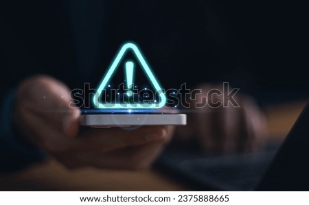 Businessman using computer laptop with triangle caution warning sign, available for notification error and maintenance concept, warning risk on device, failure security system online technology, Royalty-Free Stock Photo #2375888665