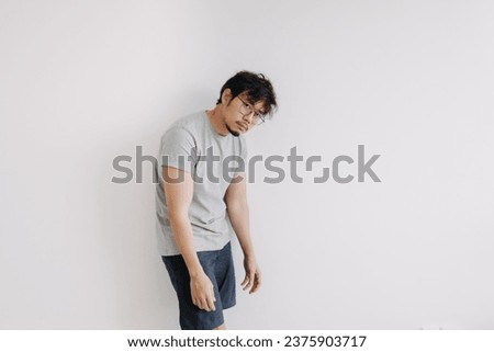 Bored face asian man stand boringly in full body isolated on white.