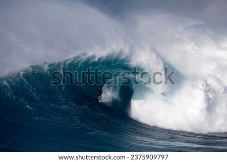 Surfing big waves at Jaws Royalty-Free Stock Photo #2375909797