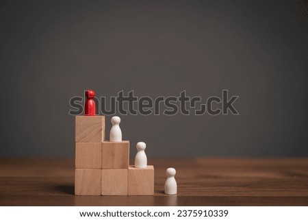 Concept of difference and leadership. White wooden puppets arranged in a circle, but one of them is red. Demonstrates distinction and leadership Royalty-Free Stock Photo #2375910339