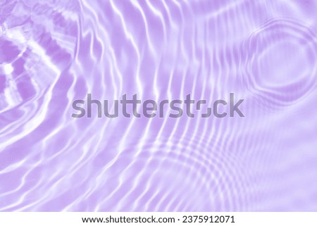  Purple water with ripples on the surface. Defocus blurred transparent pink colored clear calm water surface texture with splashes and bubbles. Water waves with shining pattern texture background.