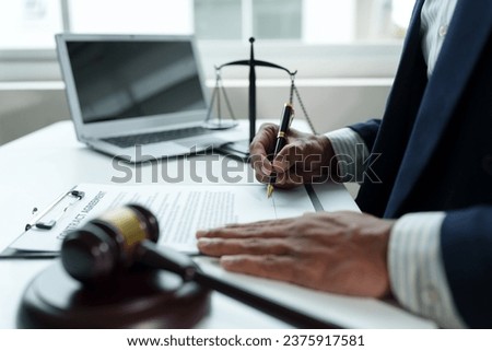 The judge is signing the document. Hammer with a Justice Lawyer Businessmen in suits or lawyers works on documents, laws, advice, and justice concepts. and signing contract