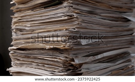 Stack business paper on desk, paperwork in office. Piled heap high documents folders