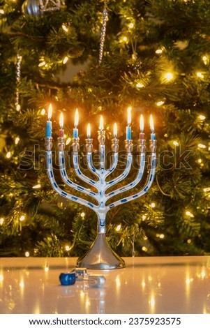On a blurred background Hanukkah menorah with candles sits on a table