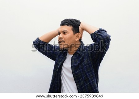 Portrait of young asian man with shocked facial expression. studio shot, isolated on white background.