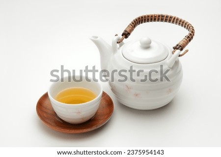 teapot and green tea on white background Royalty-Free Stock Photo #2375954143
