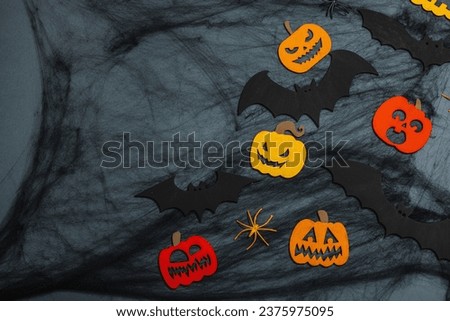 Funny Halloween background. Scary spider web, traditional fall pumpkins, bats and spiders. Festive flat lay, classic autumn style, top view