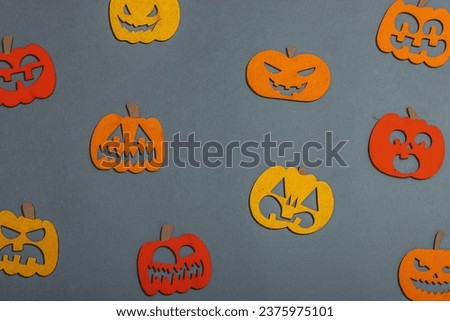 Funny Halloween background. Traditional colorful fall pumpkins with different faces. Festive flat lay, classic autumn style, top view